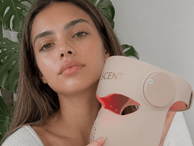 Woman holding a pink and red device with 'Inscen' branding against a neutral background