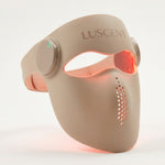 Beige Red Light Therapy LED face mask with 'Luscent' branding on a white background