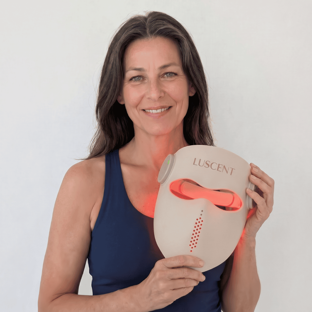 Woman holding a Luscent mask with a white background