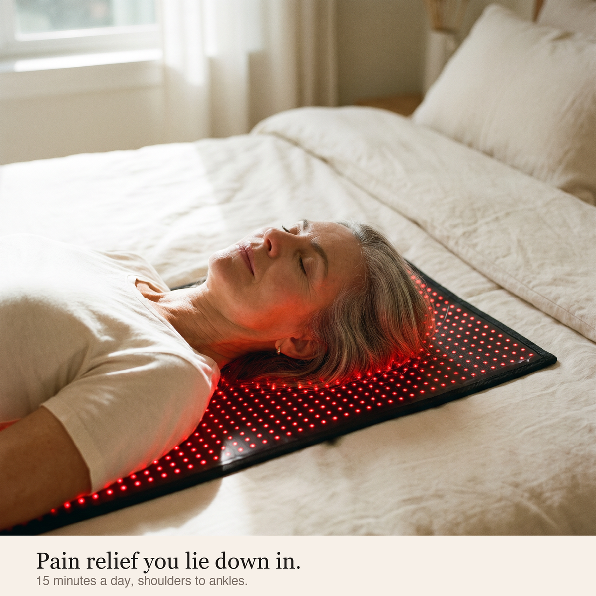 Woman resting on the glowing Luscent Red mat on a bed