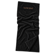 Opened black Luscent infrared sauna blanket insert with copper logo and soft cotton folds